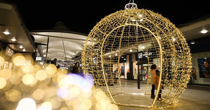woman and child standing in large Christmas decoration at Dalton Park shopping centre